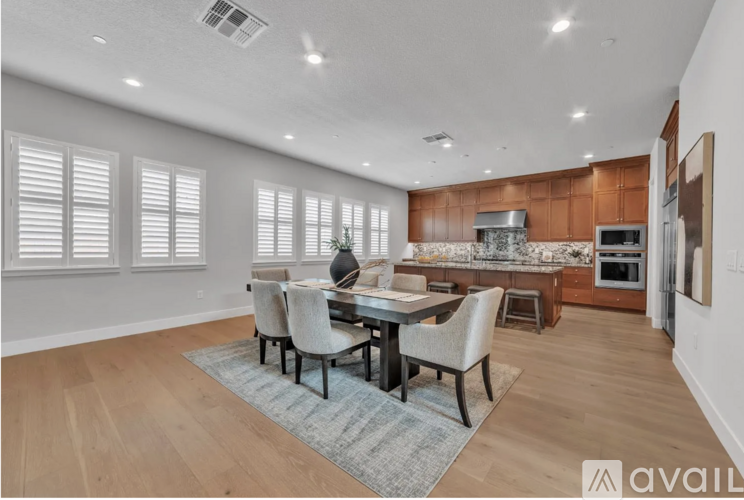 A dining room with a table set for four.