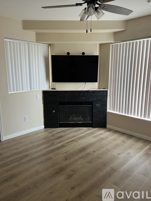 A living room with a fireplace and a television.