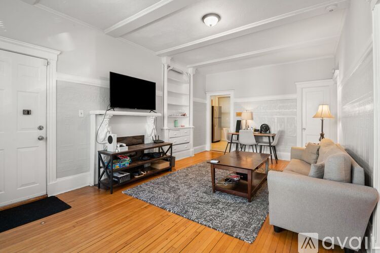 A living room with a television, a couch, and a coffee table.