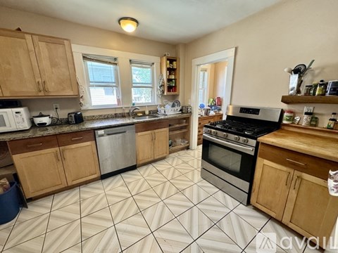 A kitchen with wooden cabinets and a black stove top oven.