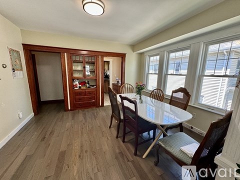 A dining room with a table set for four.