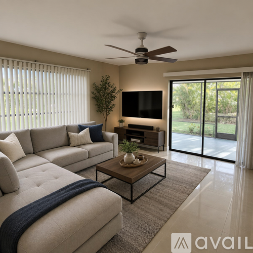 A modern living room with a large couch, a coffee table, and a flat-screen TV.