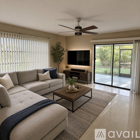 A modern living room with a large couch, a coffee table, and a flat-screen TV.