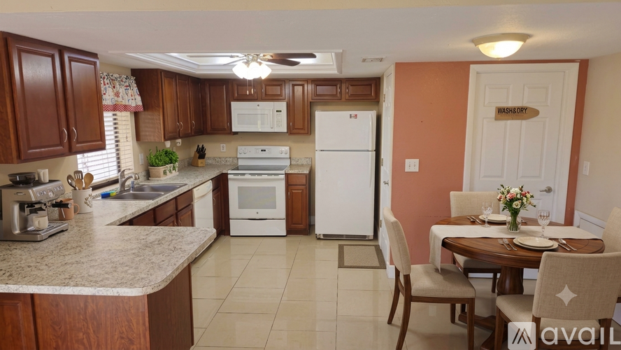 A kitchen with a table and chairs in the dining area.