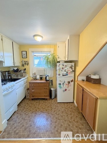 A kitchen with a white fridge and a white stove.