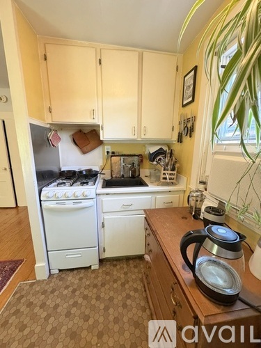 A kitchen with a white refrigerator, white oven, and white dishwasher.
