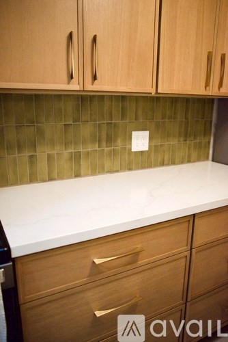 A kitchen with wooden cabinets and a white countertop.