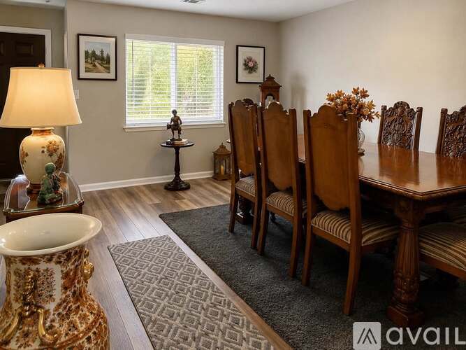 A dining room with a table set for six.