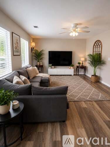 A living room with a grey couch and a television.