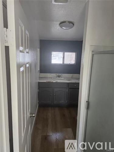 A kitchen area with a sink and cabinets.