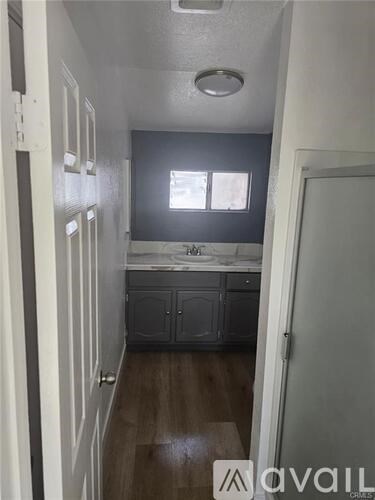 A kitchen area with a sink and cabinets.