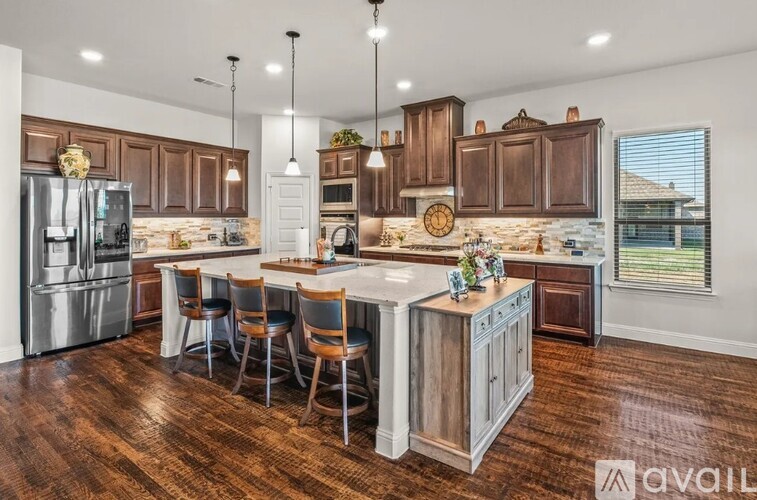 A kitchen with wooden cabinets and a central island.