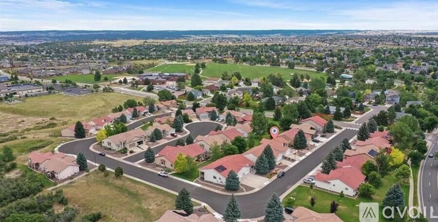 A bird's eye view of a suburban neighborhood with houses and trees.