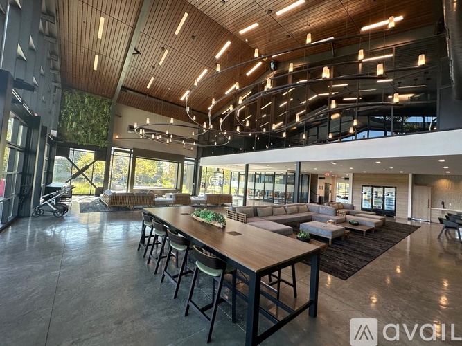 A modern living room with a long wooden table and chairs.