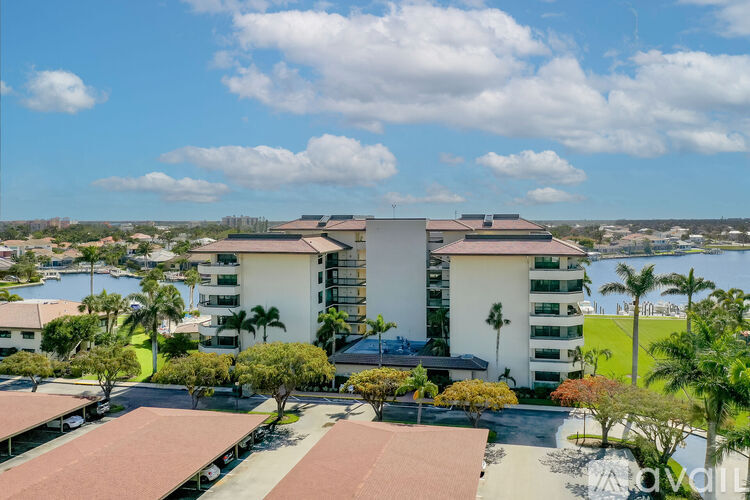A view of a building with a green area in front of it.