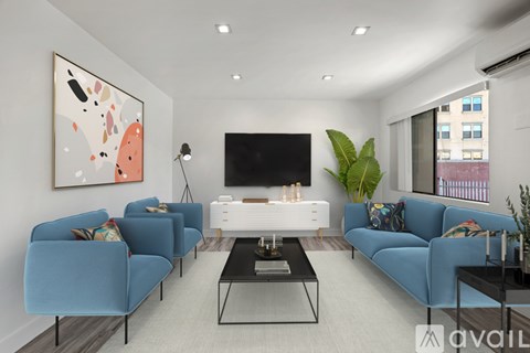 A living room with blue couches and a television.
