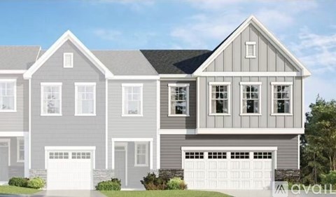 A modern two-story house with a garage on the ground floor.