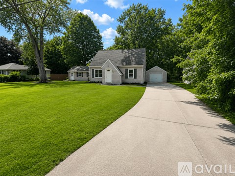 A house with a driveway in front of it is for sale.