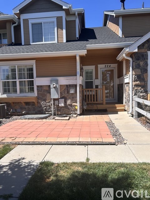 A house numbered 224 has a porch with a tiled floor.