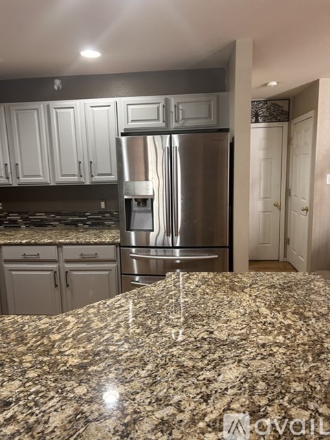A kitchen with granite countertops and stainless steel appliances.