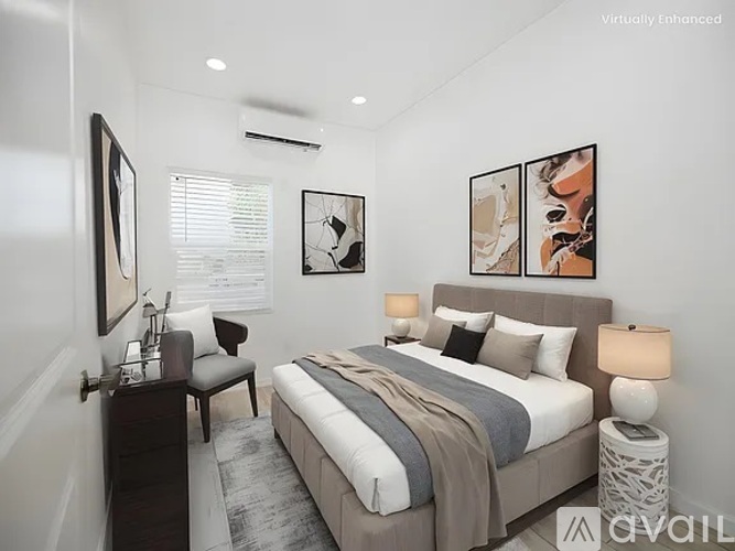 A bedroom with a bed, nightstand, and a chair.