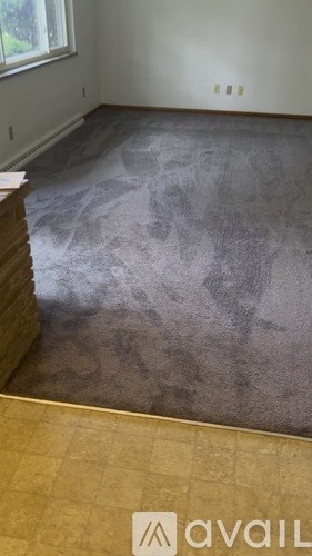 A room with a grey floor and a window.