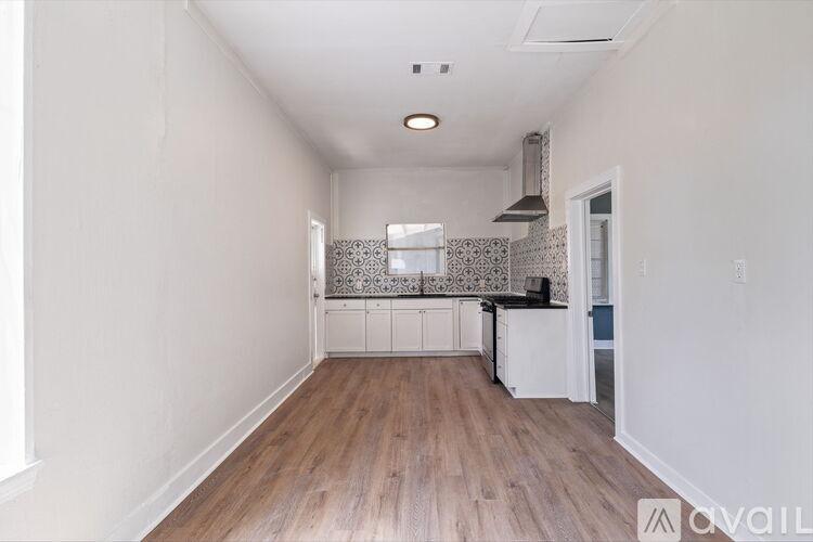 A kitchen area with a counter and a stove top oven.