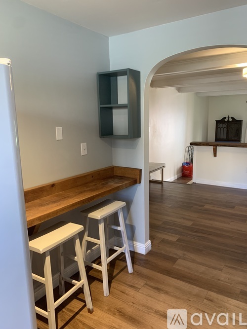 A kitchen with a bar area and stools.