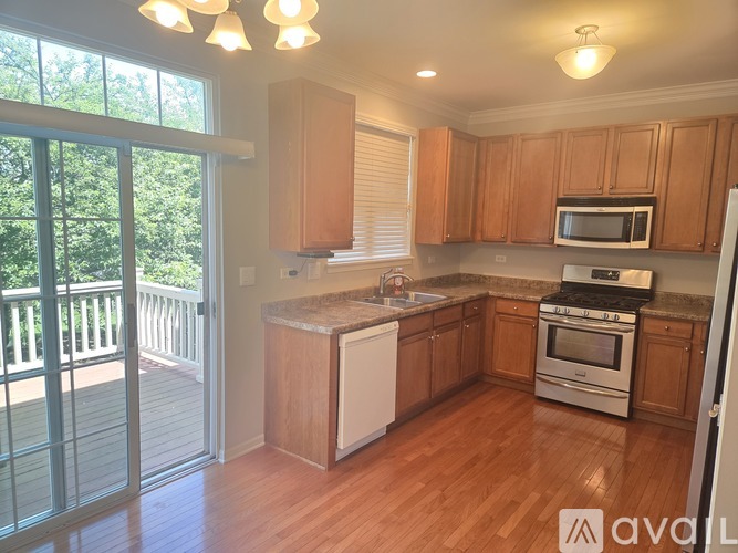 A kitchen with wooden cabinets and a white dishwasher.