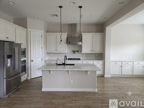 A modern kitchen with white cabinets and a central island.