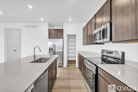 A kitchen with brown cabinets and a white countertop.