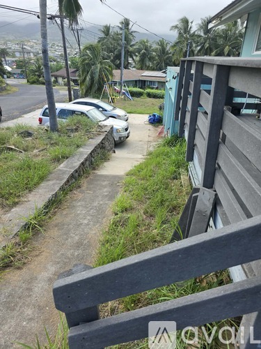 A white car is parked on the side of a road.