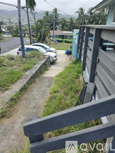 A white car is parked on the side of a road.