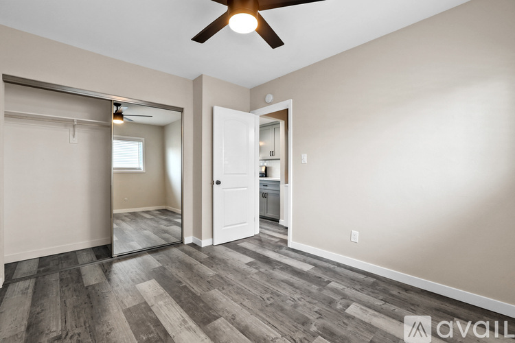 A room with a wooden floor and a ceiling fan.