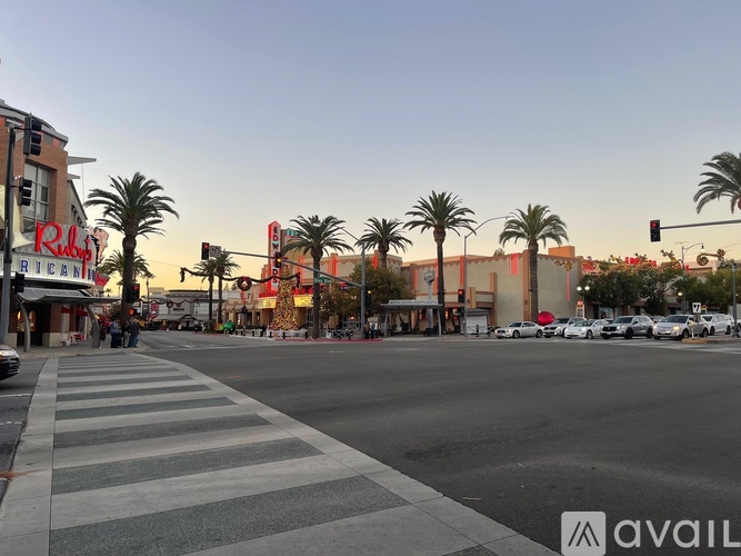 A street view with palm trees and a building with a red sign that says "Ruby's".