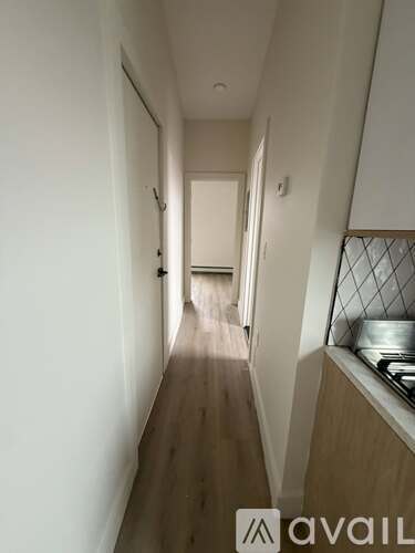 A long hallway with a kitchen area on the right.
