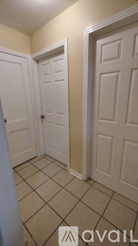 A room with two doors and tiled flooring.
