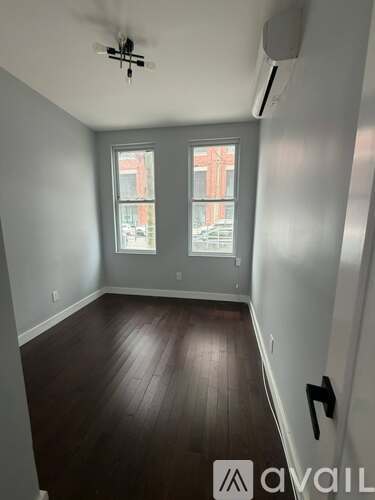 A room with a window and a ceiling fan.