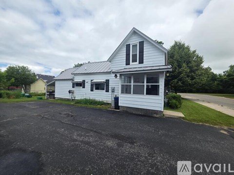 A two-story house with a garage is available for rent.