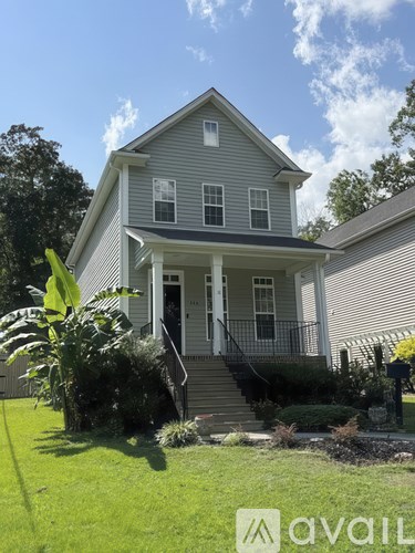 A house with a front yard and a mailbox.