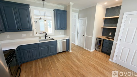 A kitchen with dark blue cabinets and a white countertop.