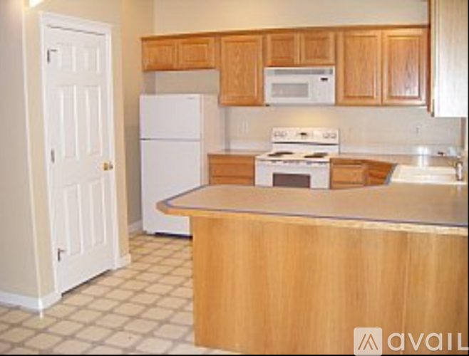 A kitchen with a white refrigerator and white stove.