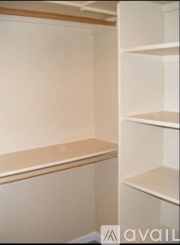 A white refrigerator with three shelves is available for rent.