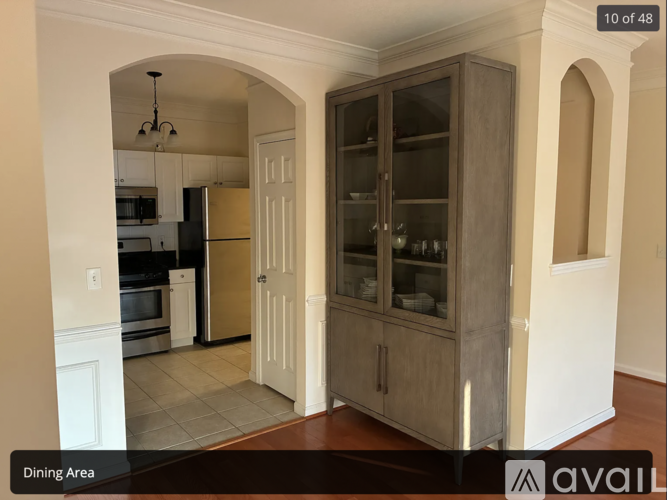 A dining area with a wooden cabinet and a glass door.