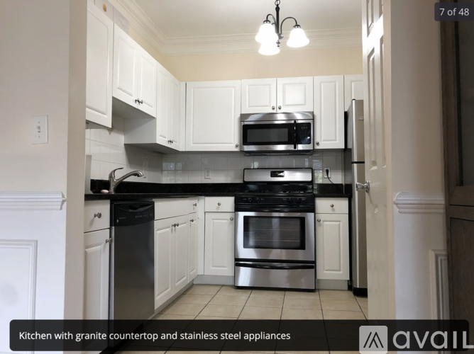 A kitchen with granite countertop and stainless steel appliances.