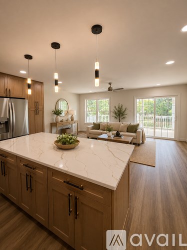 A modern kitchen with wooden cabinets and a marble countertop.