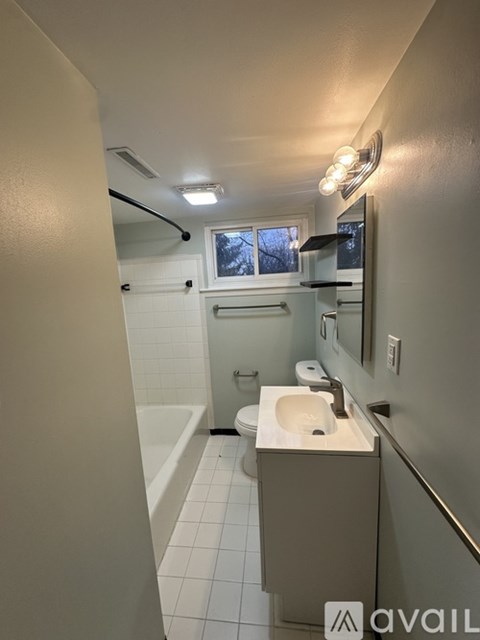 A bathroom with a sink, toilet, and bathtub.