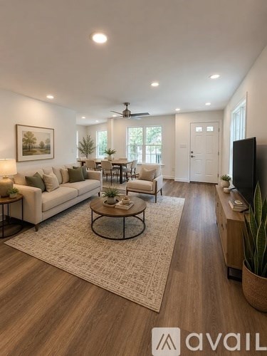 A living room with a sofa set, a coffee table, and a television.