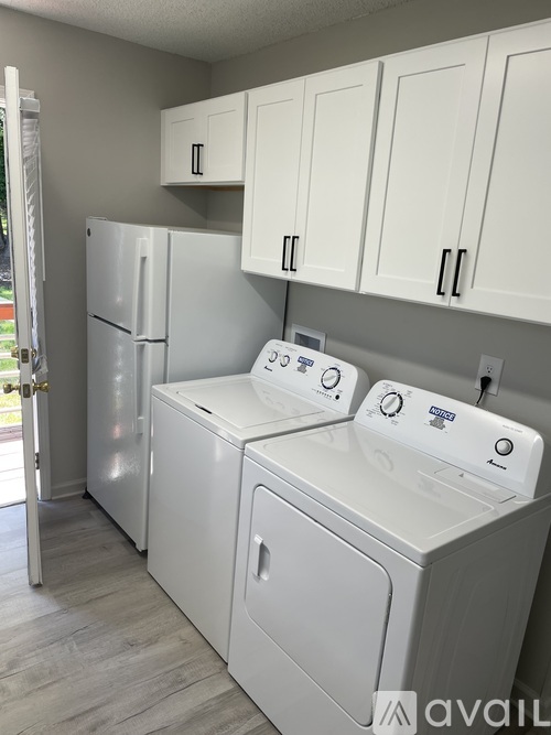 A white washer and dryer in a laundry room.