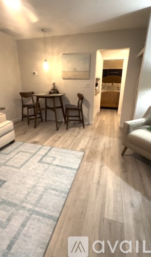 A living room with a dining table and chairs.